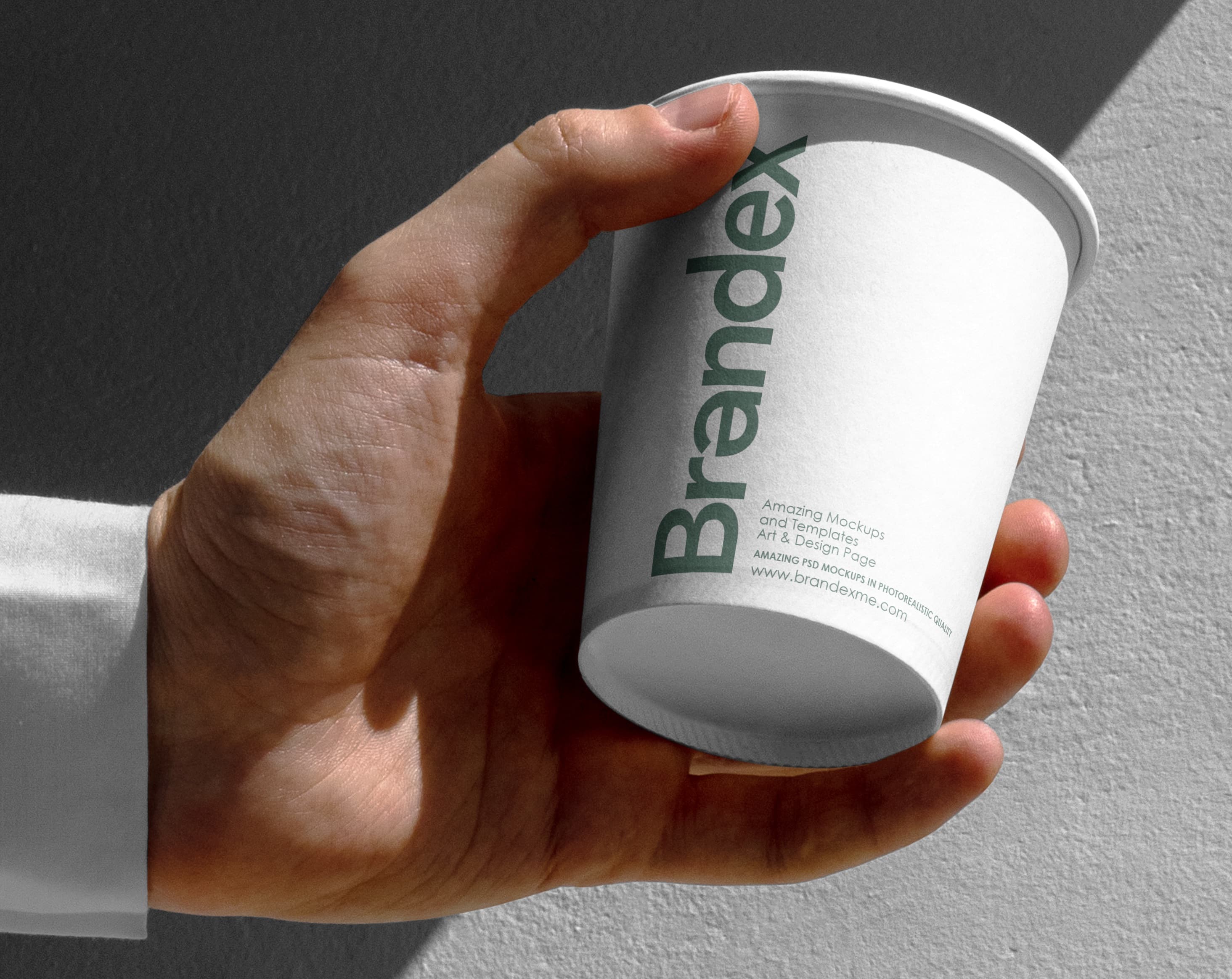 Handheld paper coffee cup mockup