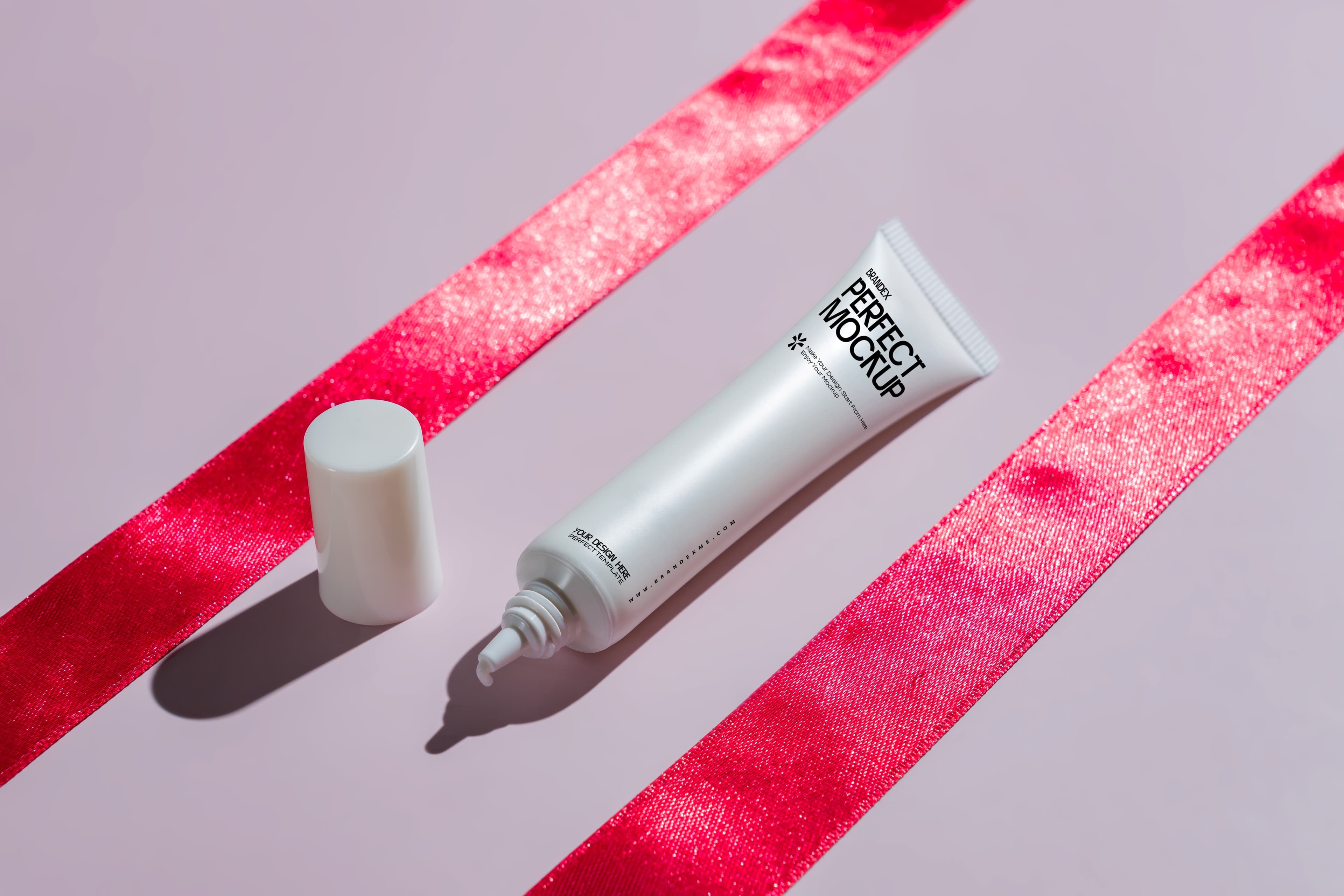Cosmetic tube on pink surface mockup