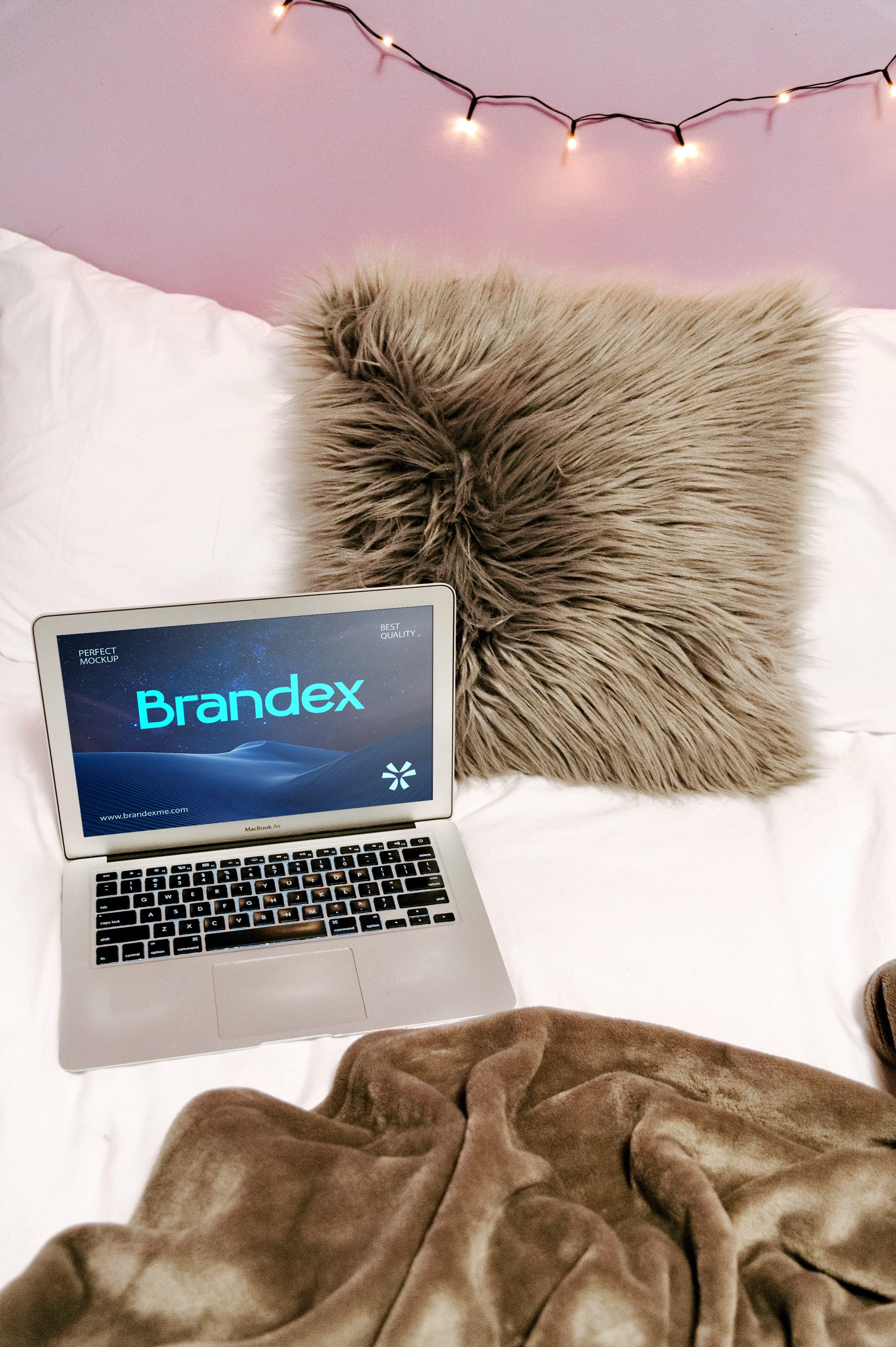 Laptop on cozy bed mockup