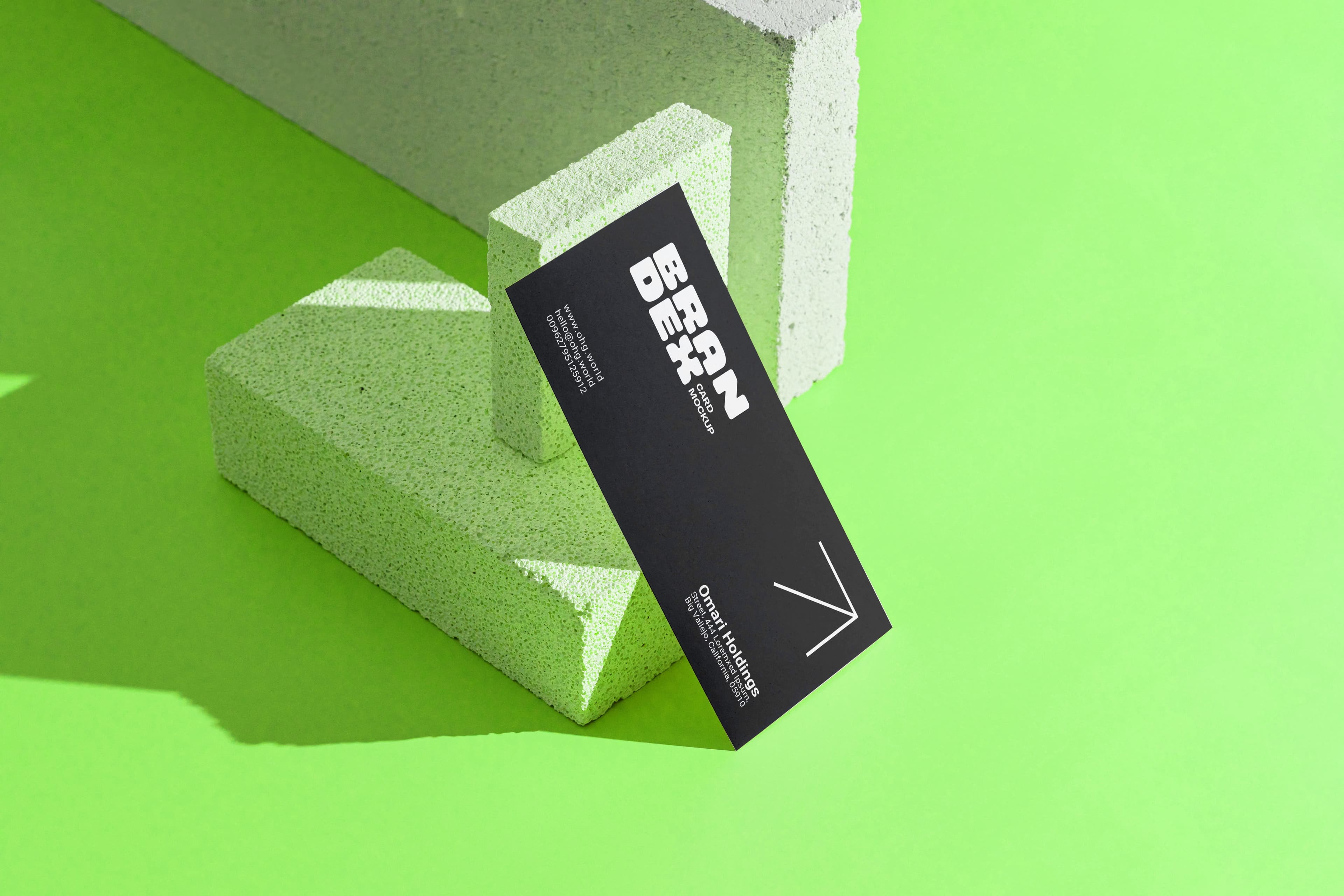 Black business card mockup on green bricks