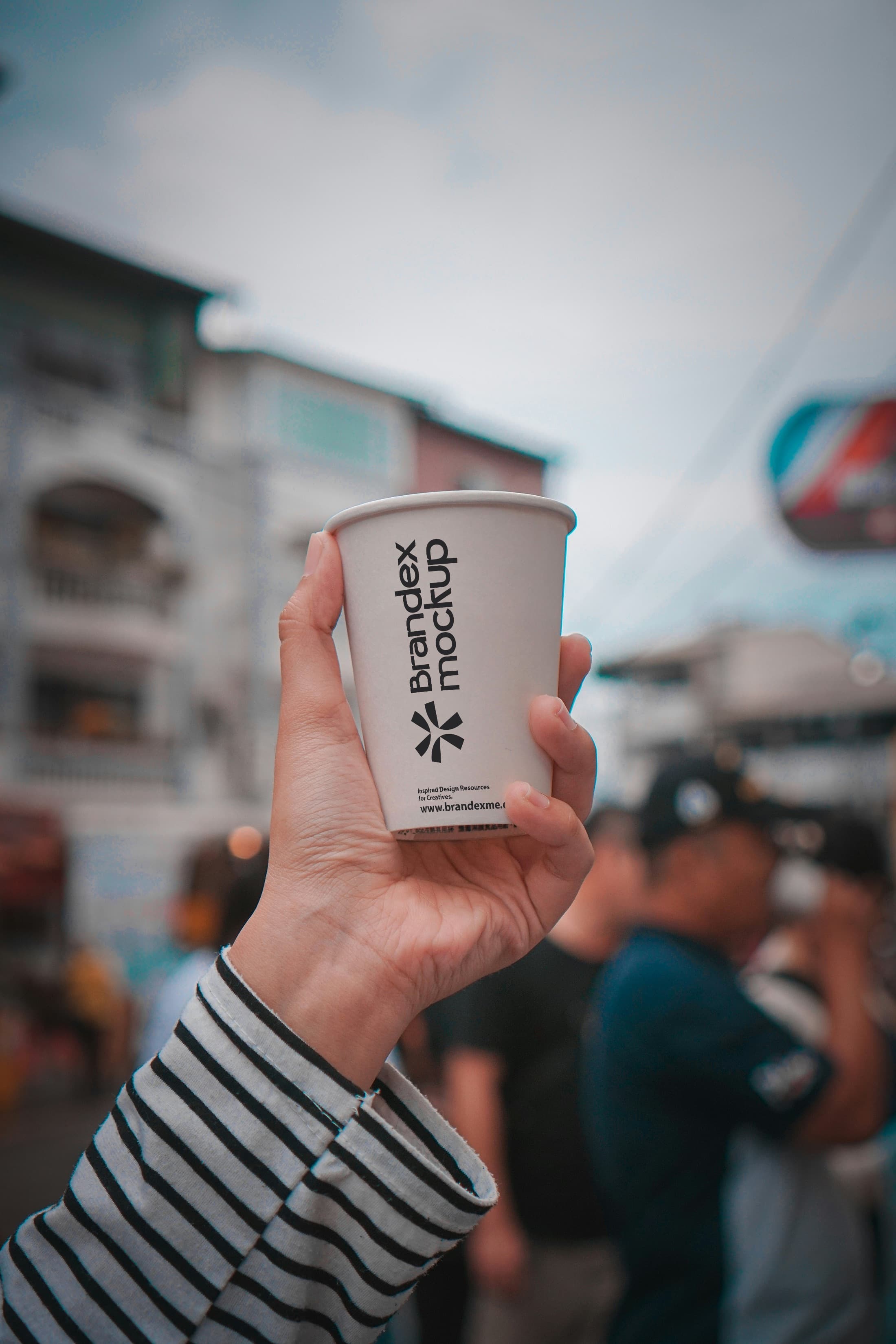 Handheld paper coffee cup mockup