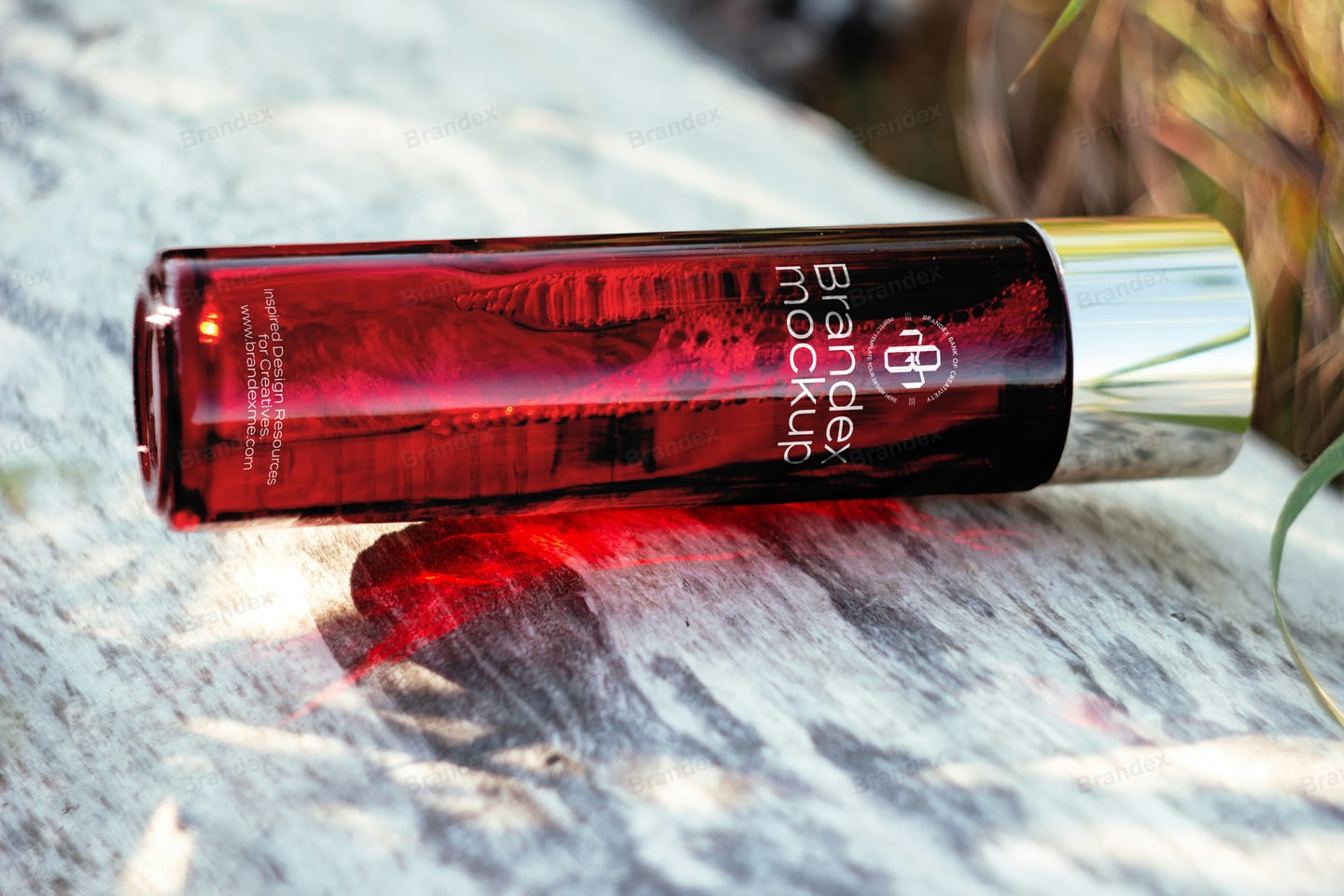 Red Glass Cosmetic Bottle Mockup Lying Outdoor on Natural Stone